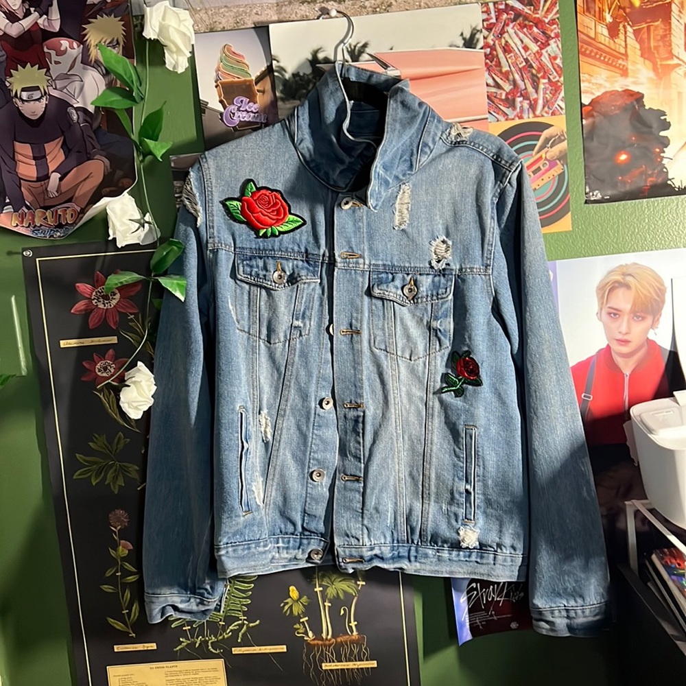 A blue Jean jacket with the reps on it and Red flowers